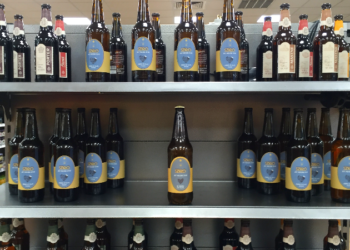 Glass bottles of beer on display in a store